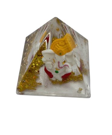 Decorative resin pyramid containing a Lord Ganesha idol and gold-colored flakes