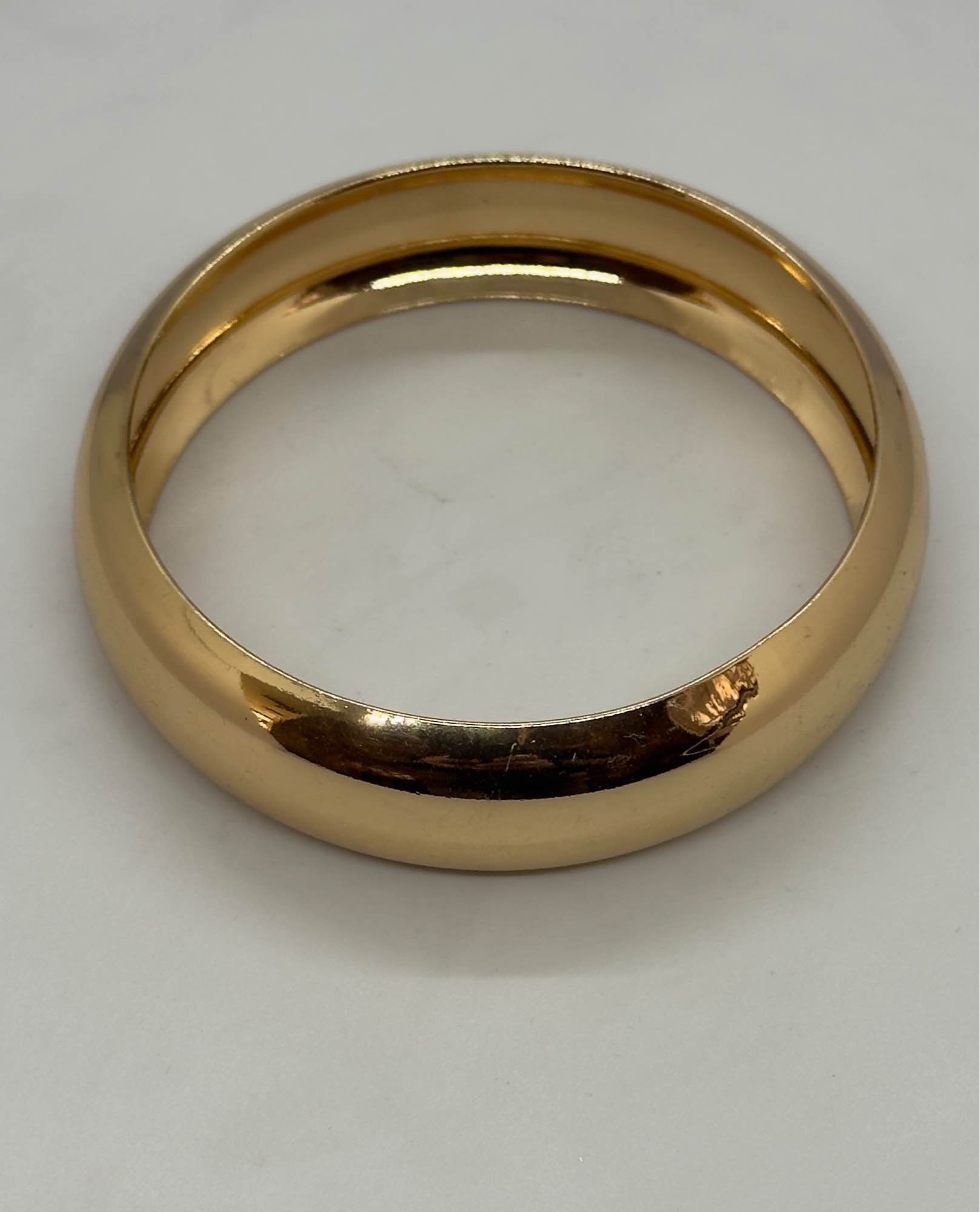 Highly polished gold plated bangle bracelet with a classic
