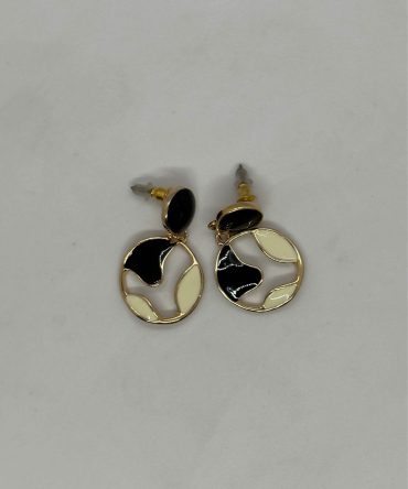 Vintage-style golden-tone drop earrings featuring a monochrome enamel design in black and cream